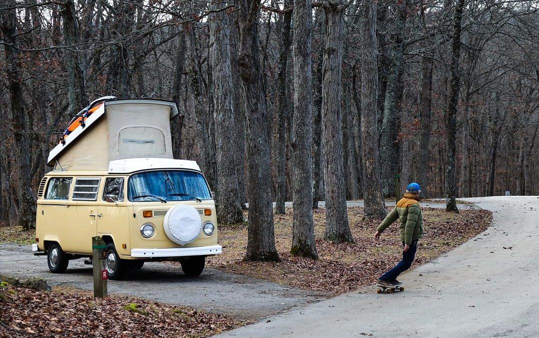 Norris skateboarding in front of his van