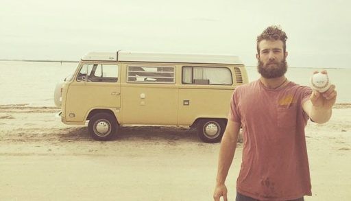 Norris in front of his van with a baseball
