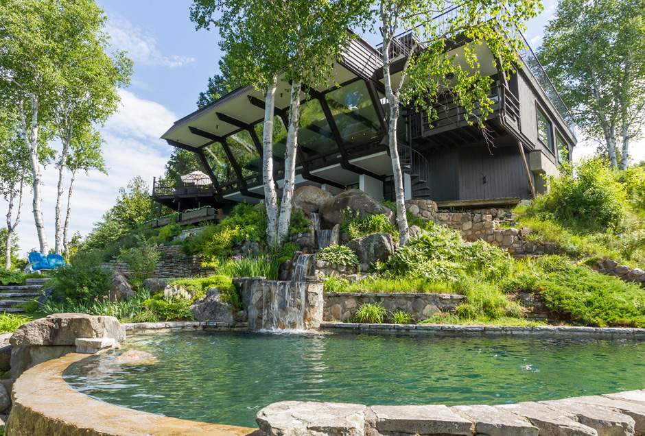 Outdoor view of pool and cottage
