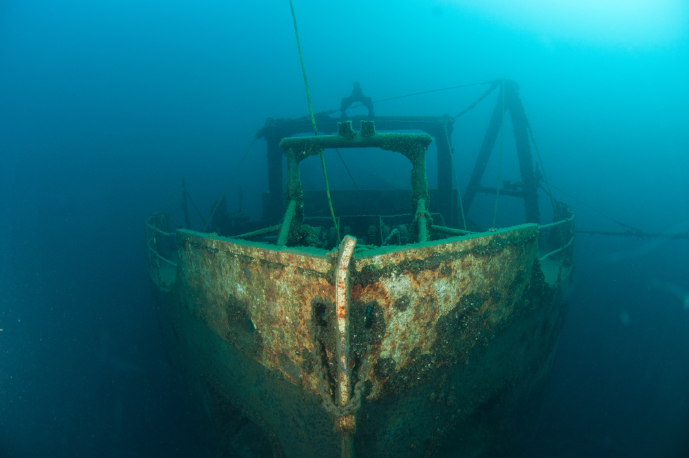 Shipwreck decaying at the bottom of the ocean.