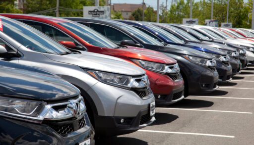 SUVs lined up in a car lot.