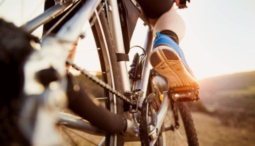 Person riding a bike in a rural area.