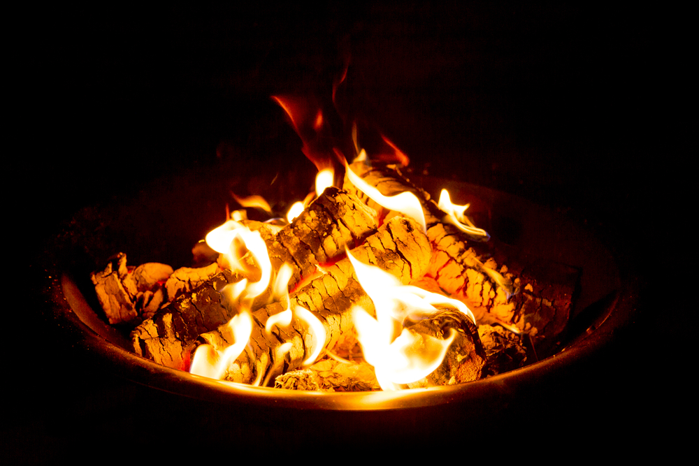 Close-up of a burning campfire at night.