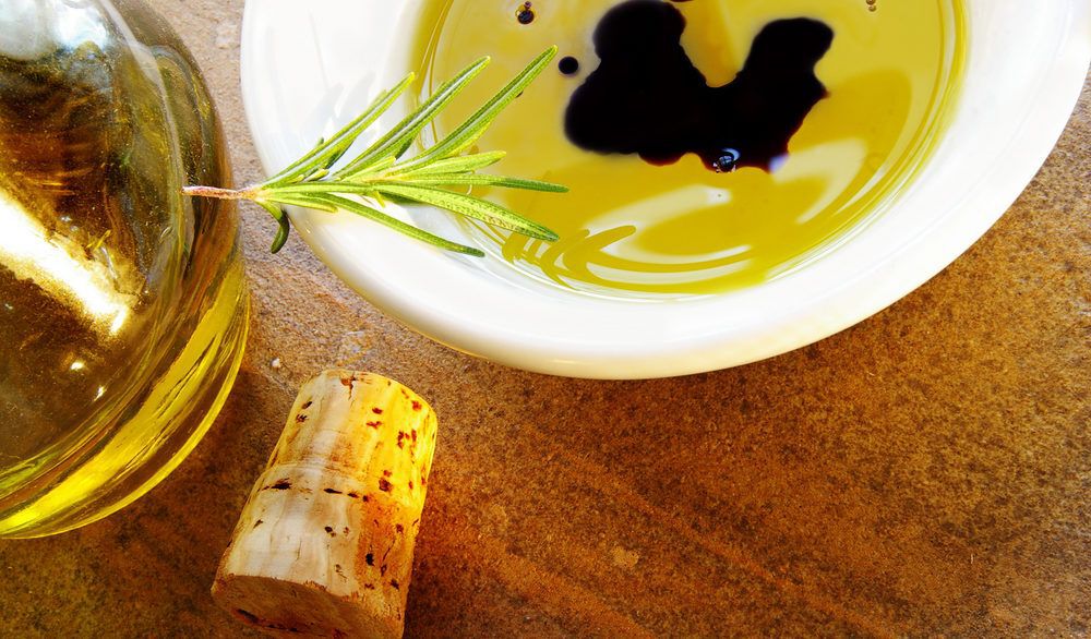 Dipping oil for bread on a wooden table.