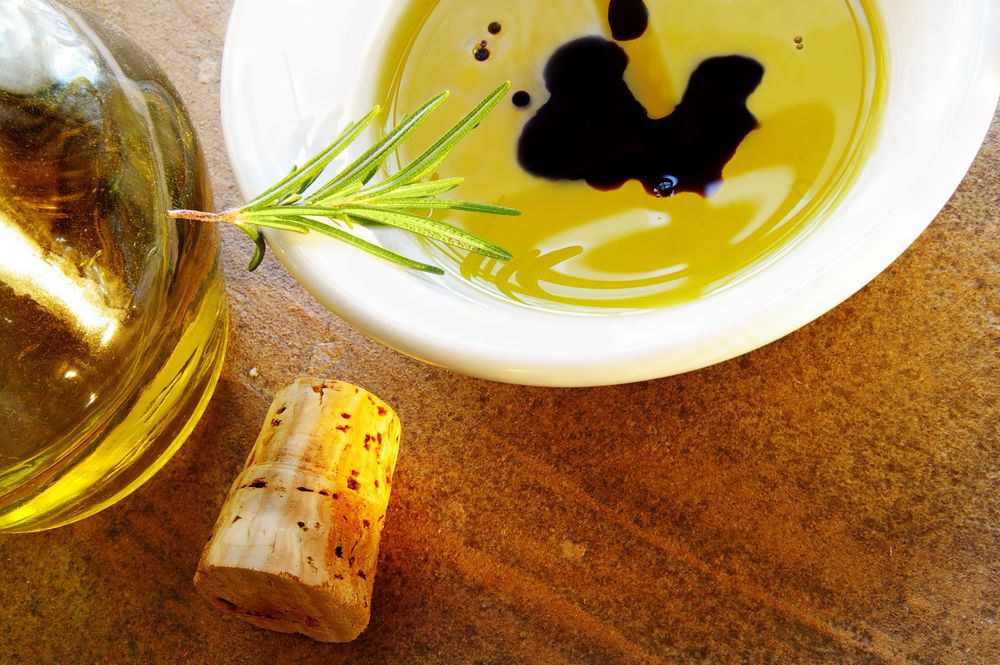 Dipping oil for bread on a wooden table.