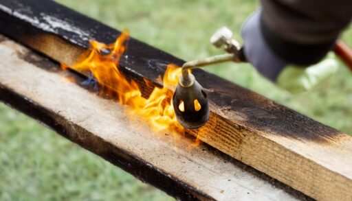 Wood being torched to achieve charred wood.