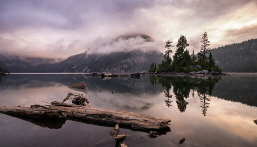 Long exposure image of mountains by a body of water in B.C., Canada.