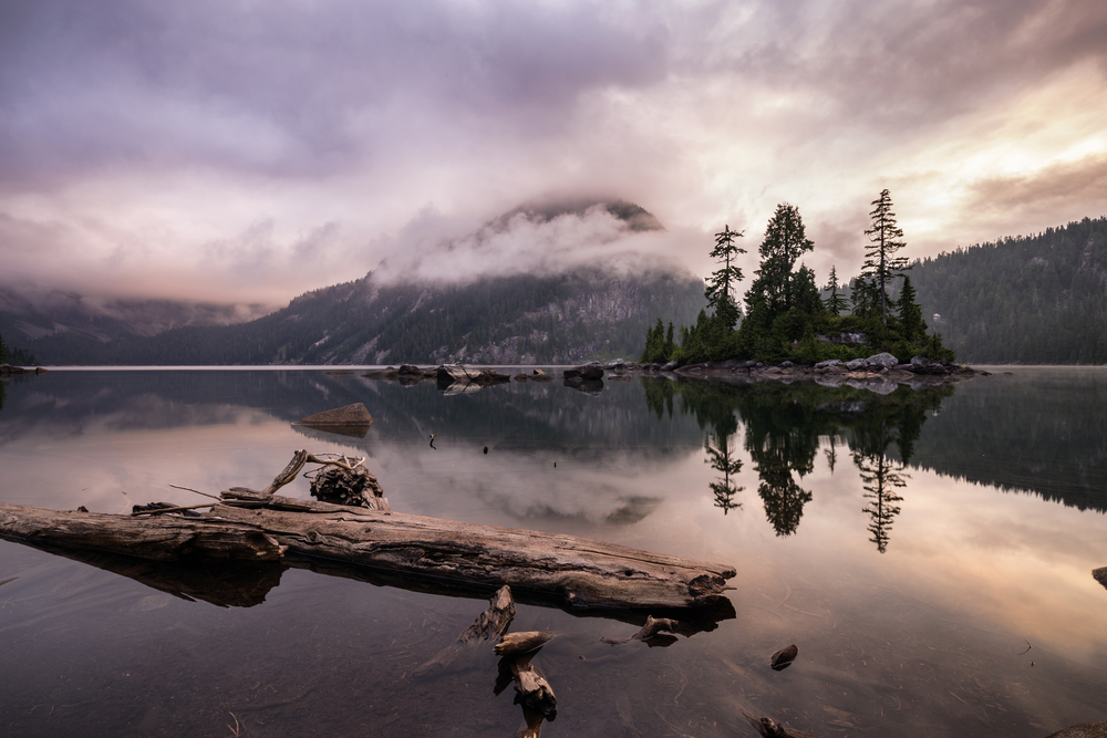 Long exposure image of mountains by a body of water in B.C., Canada.