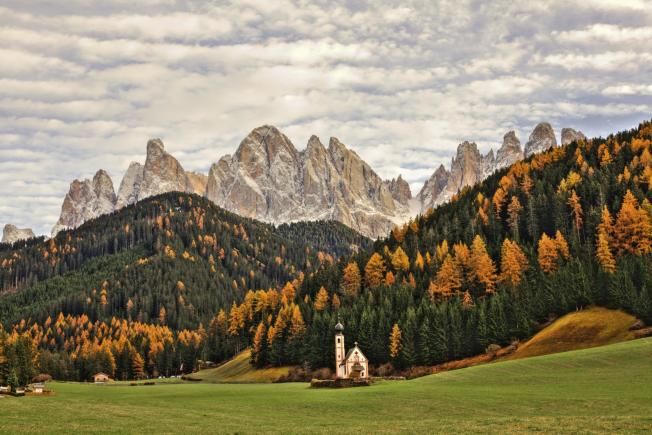 Church at foot of forest and mountains