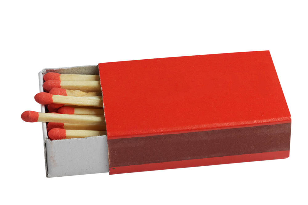 Red box of matches with red-tipped matches inside.