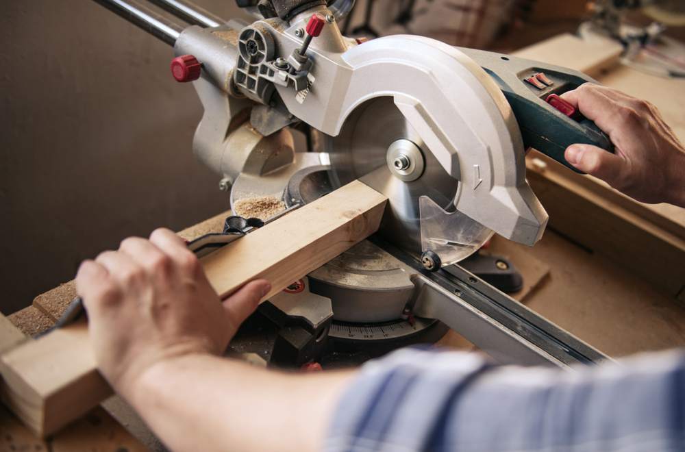 Close-up of a person using a table saw.