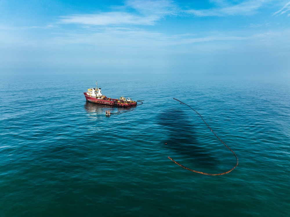 Ship trying to contain an oil spill in the ocean.