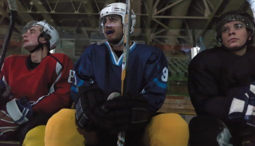 Hockey players sitting on the bench.