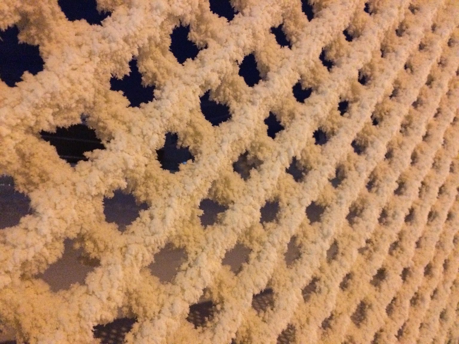 Chain-link fence covered in snow