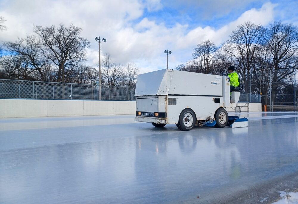 White Zamboni cleaning ice rink.