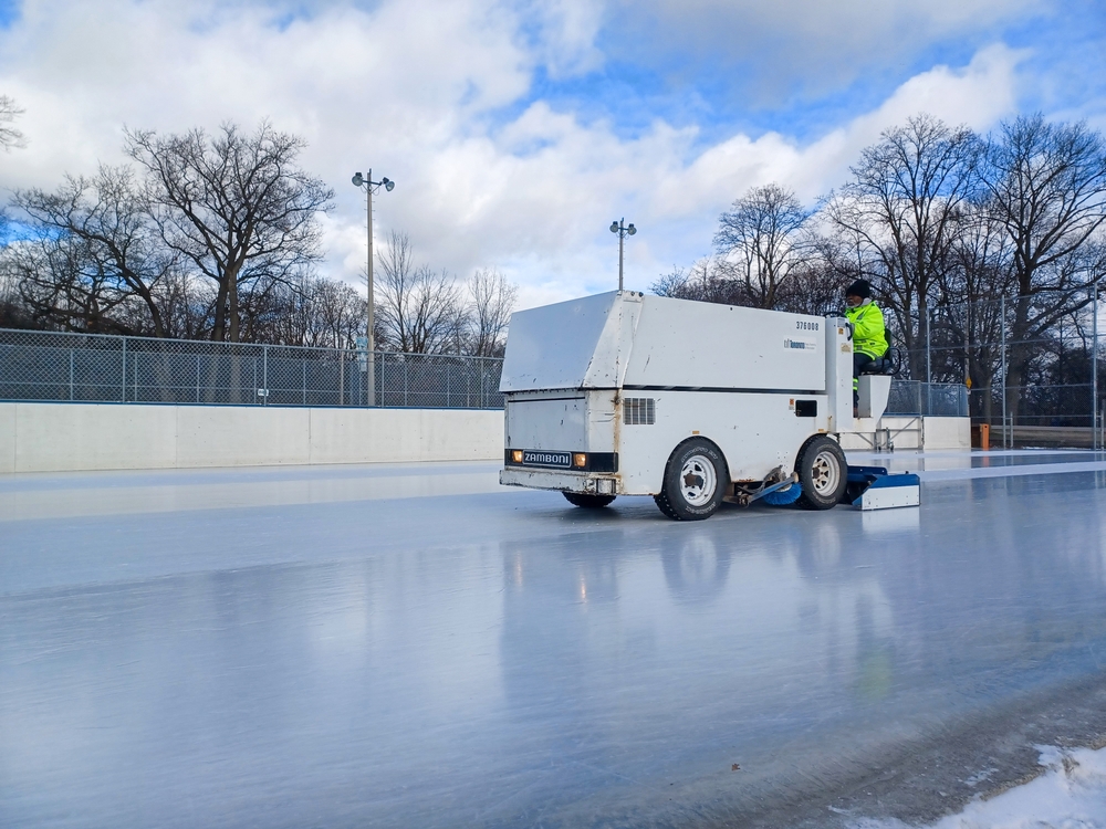 White Zamboni cleaning ice rink.