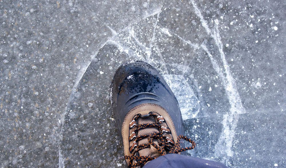 Person walking on thin ice that is beginning to break.