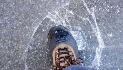 Person walking on thin ice that is beginning to break.
