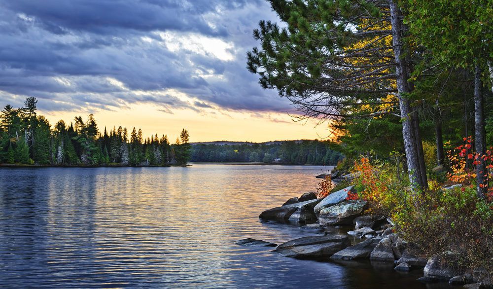 Dramatic sunset above a peaceful lake in Algonquin Park, Ontario, Canada.