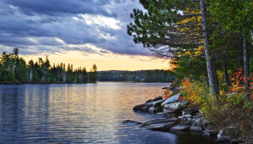 Dramatic sunset above a peaceful lake in Algonquin Park, Ontario, Canada.