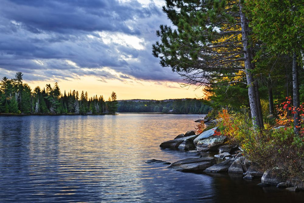 Dramatic sunset above a peaceful lake in Algonquin Park, Ontario, Canada.