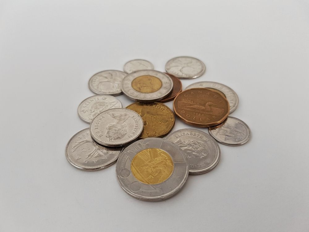 Canadian coins in a pile.