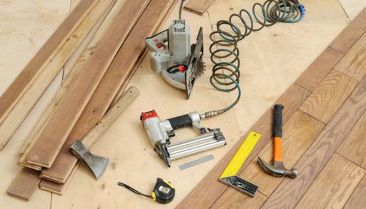 Essential power tools being used to install flooring.
