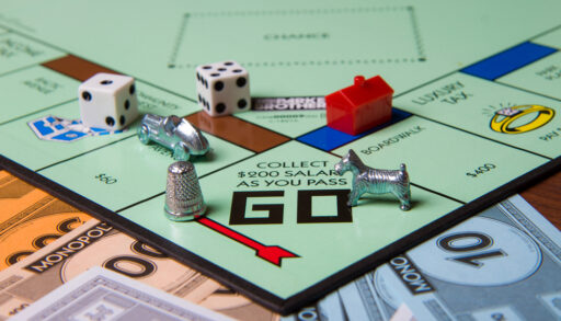 Monopoly game pieces on the Monopoly board.