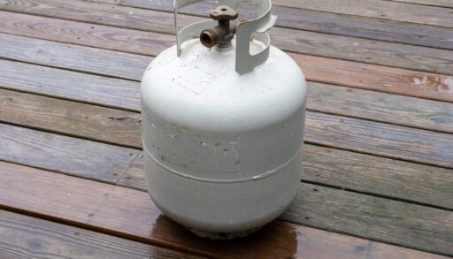 Propane tank on a wooden deck.