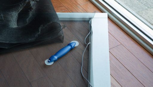 Replacing a ripped screen door.