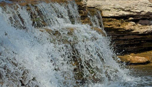 Cascading waterfall flowing down rocks.
