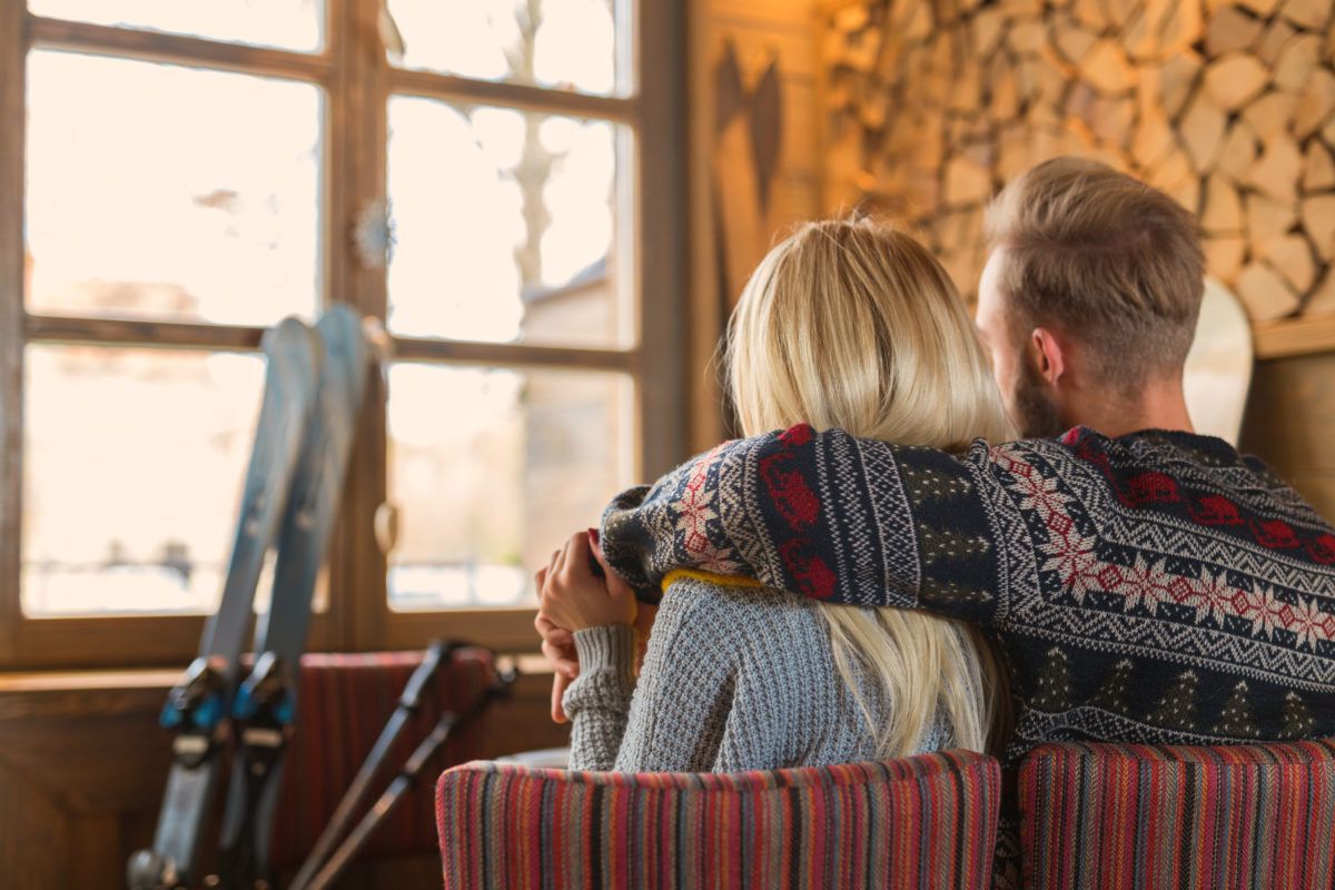a-young-couple-at-a-cottage-in-winter-skiing-vacation