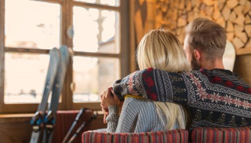 a-young-couple-at-a-cottage-in-winter-skiing-vacation