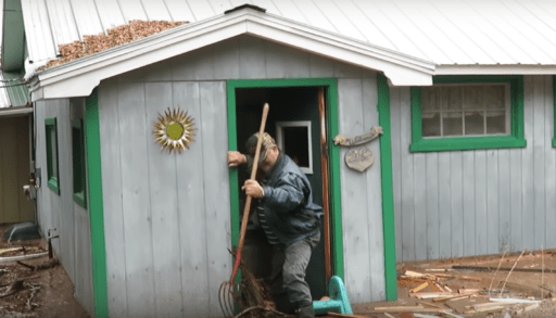 Bob McNee entering his flooded cottage