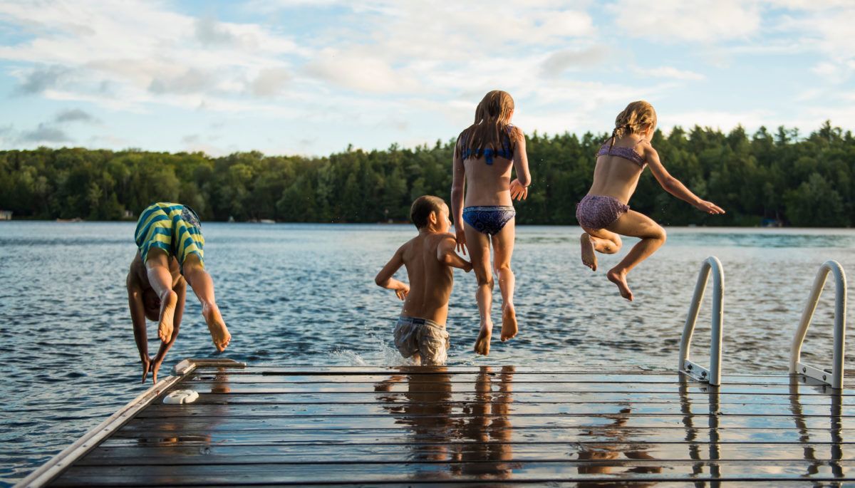 kids-jumping-off-dock-into-lake