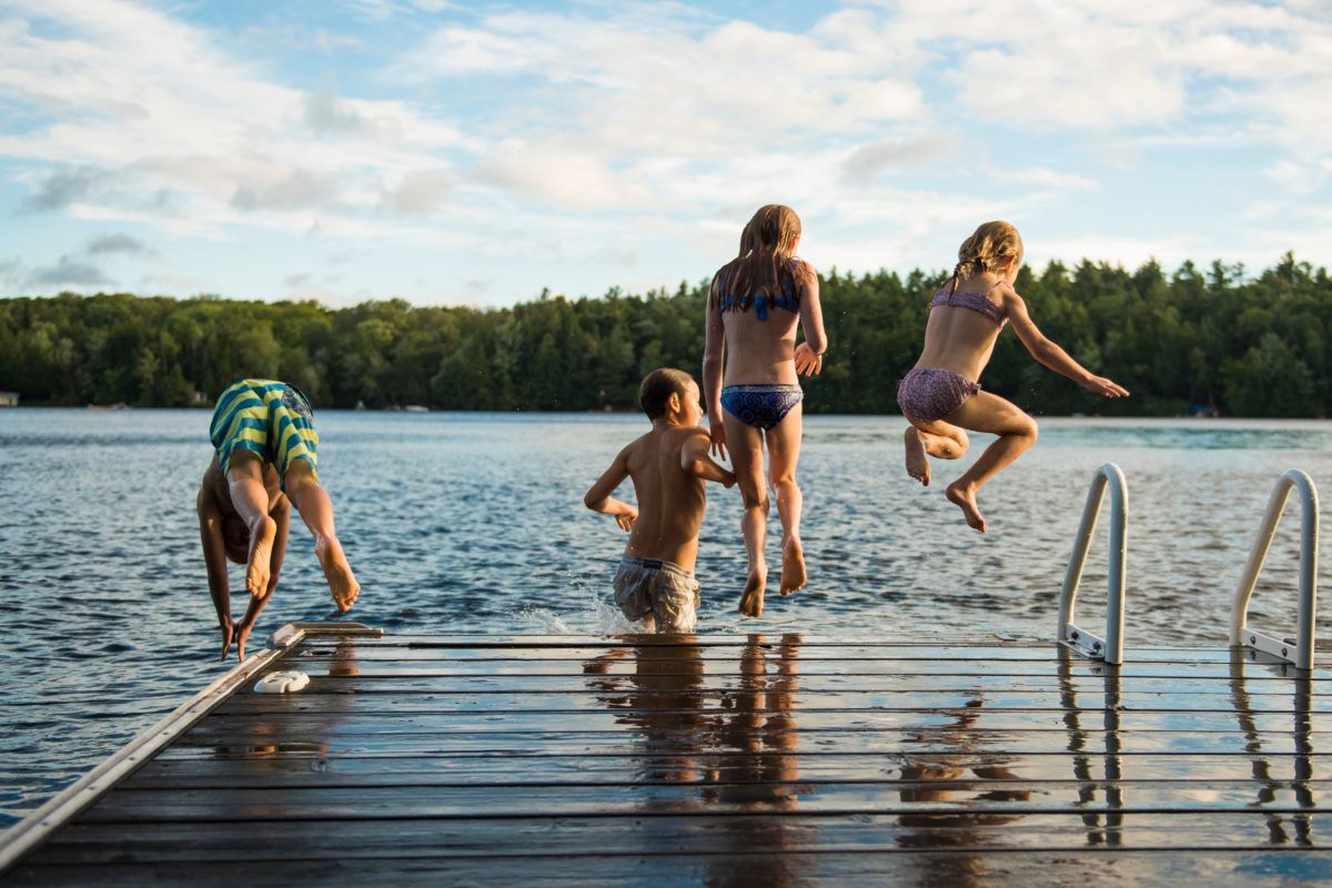 kids-jumping-off-dock-into-lake