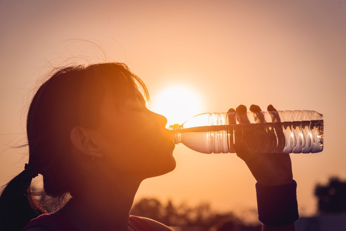 woman-in-hot-weather-drinking-water-bottle