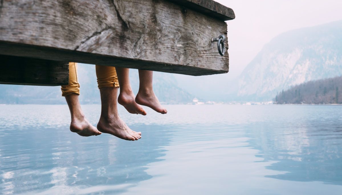 father-and-son-sitting-on-dock-by-lake