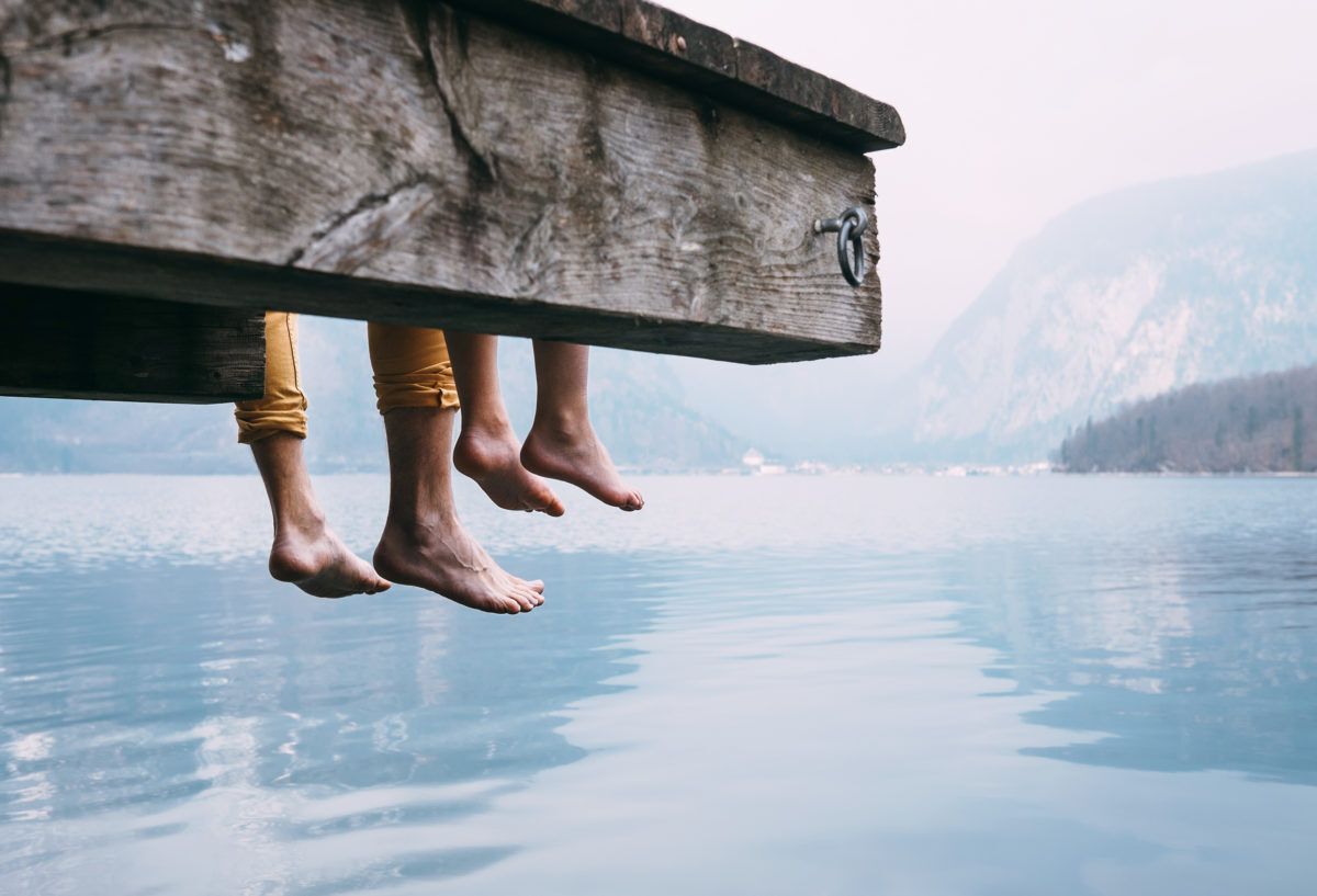 father-and-son-sitting-on-dock-by-lake