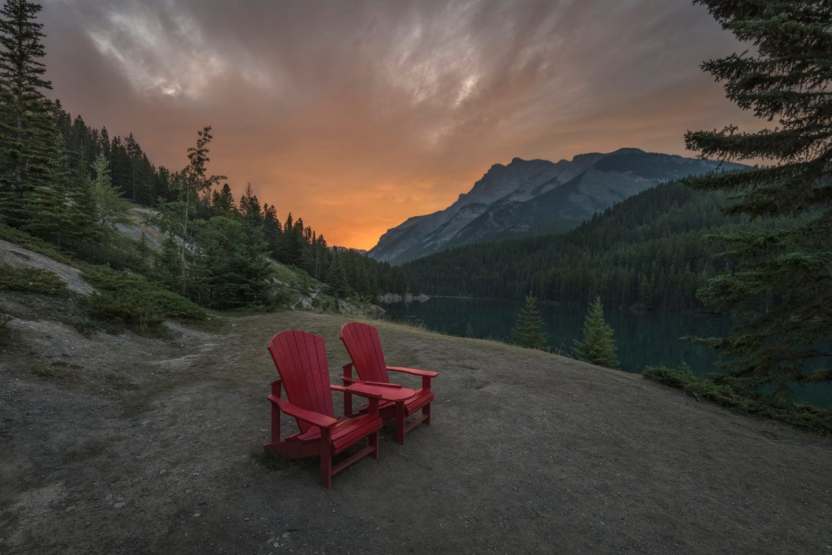 Red chairs at Two Jack Lake in Banff National Park, Canada