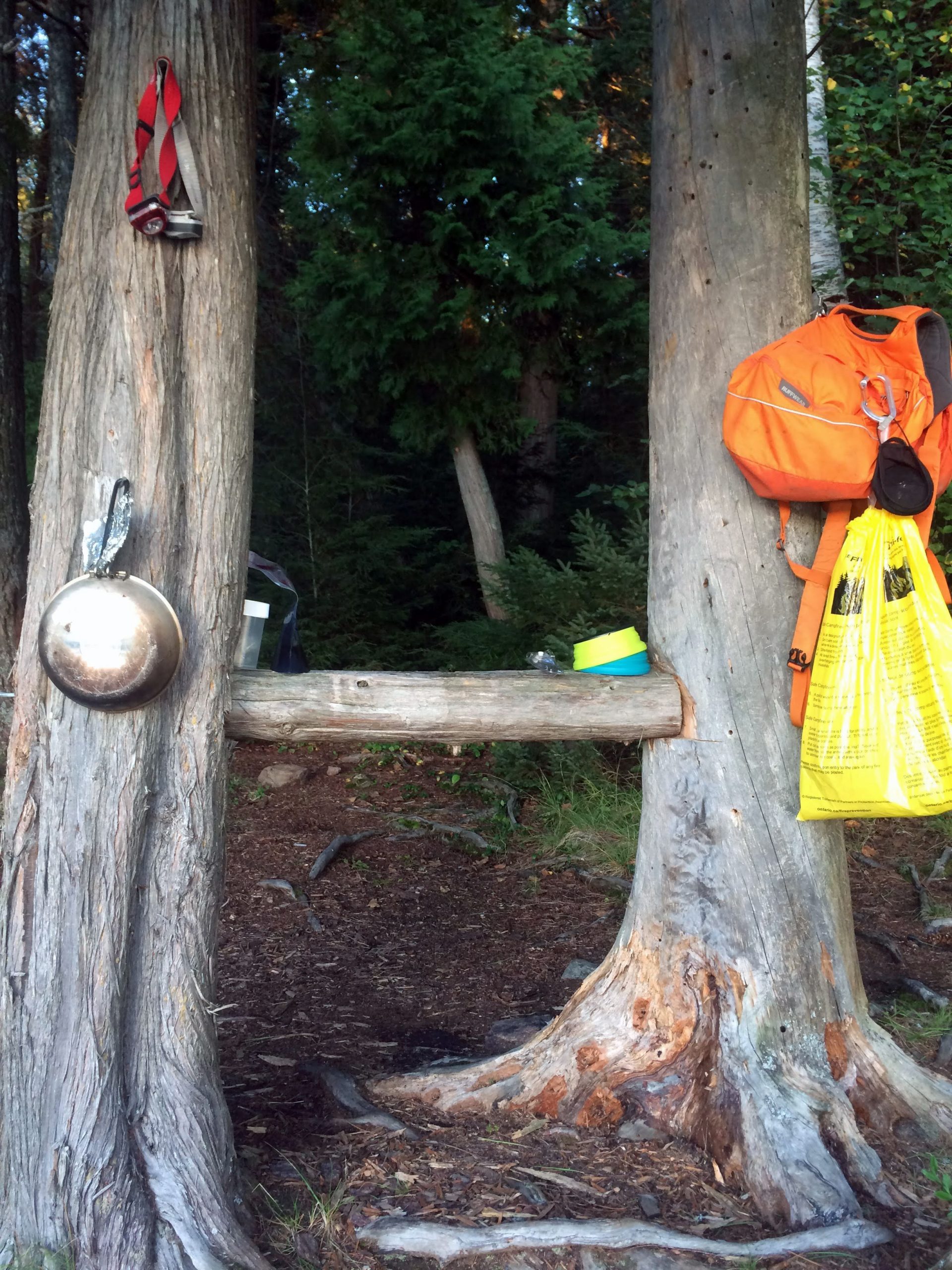 a campsite with a bench and other amenities.