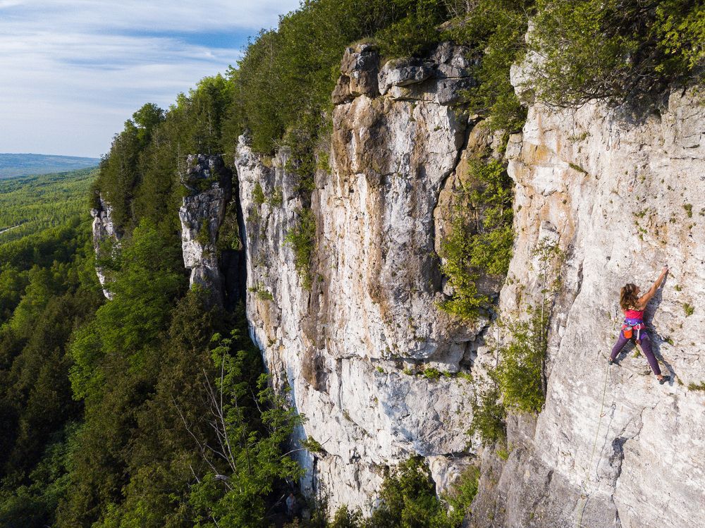 A woman climbing Old Baldy, perched more than 150 metres above the Beaver Valley.