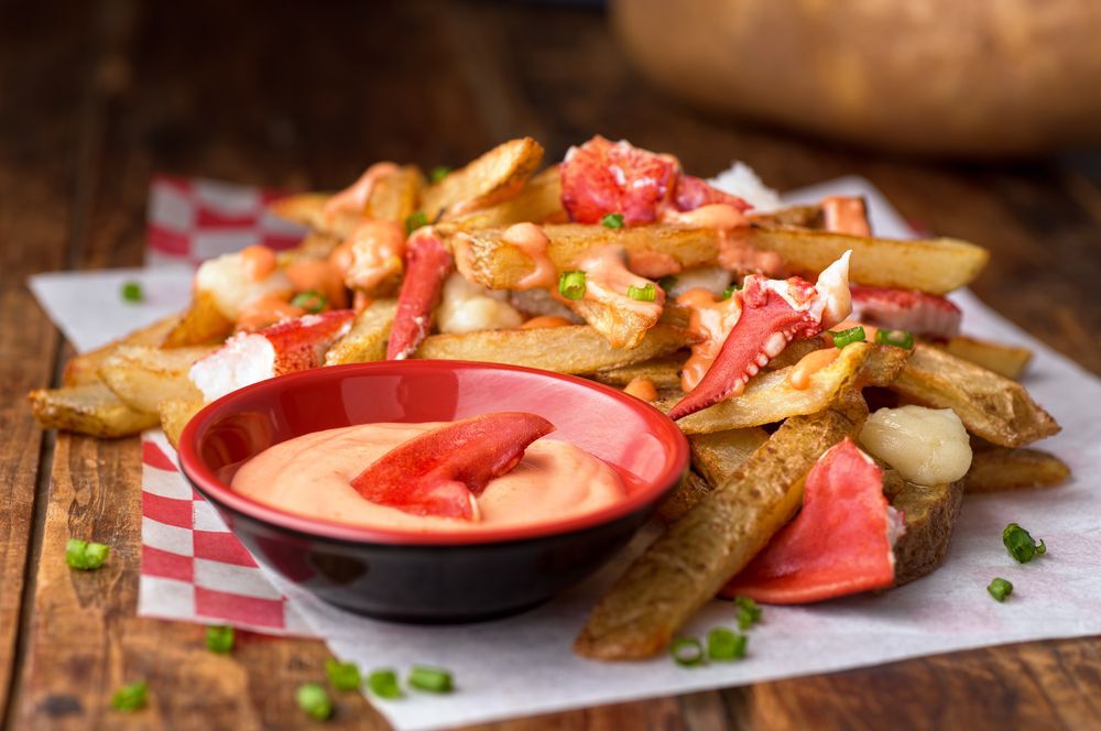 Lobster poutine on a red checkered napkin