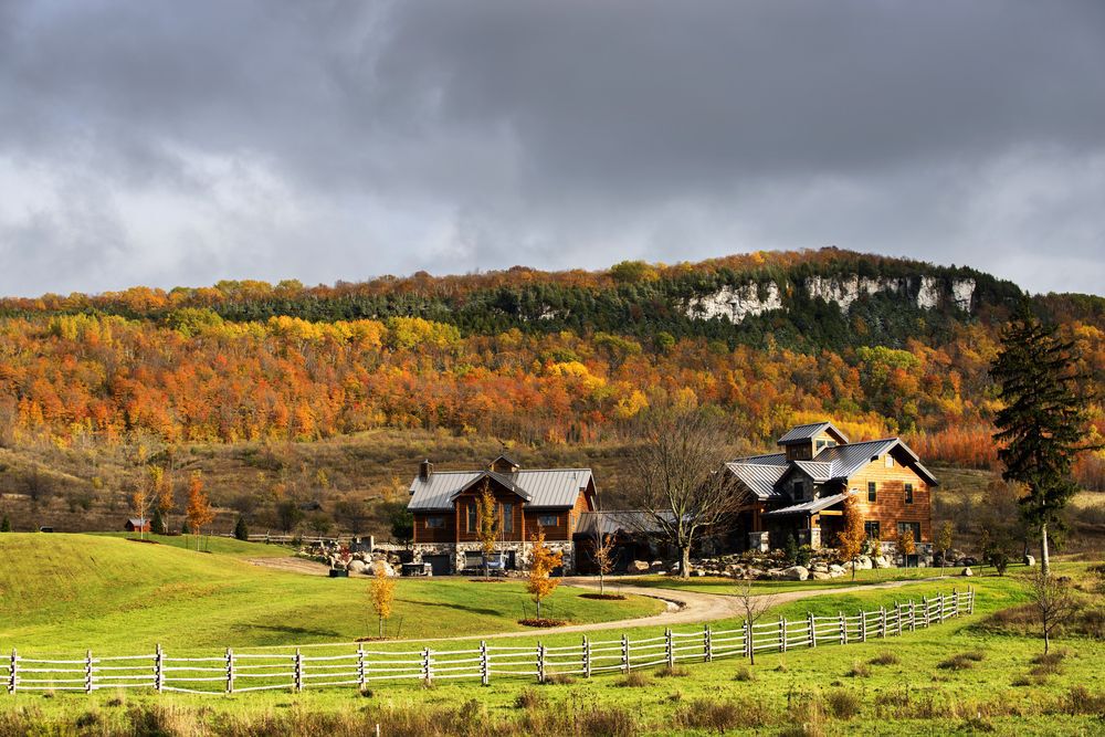 A farmhouse in autumn with storm clouds