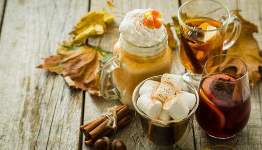 Selection of autumn drinks on wood background