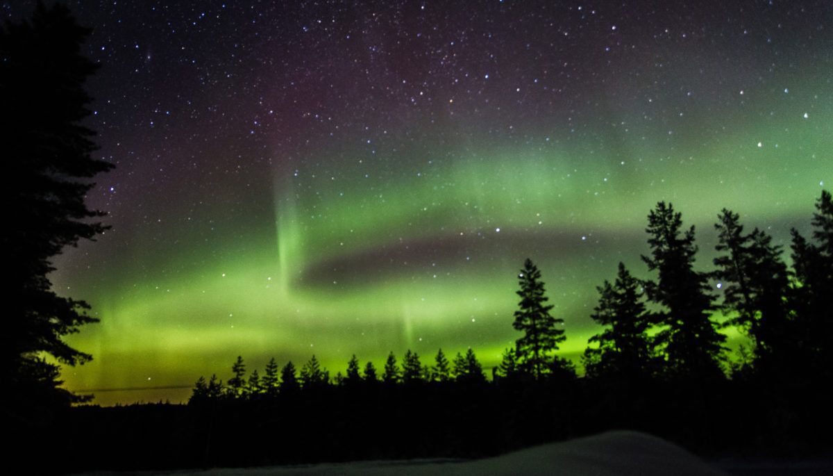 Green northern lights illuminate the night sky