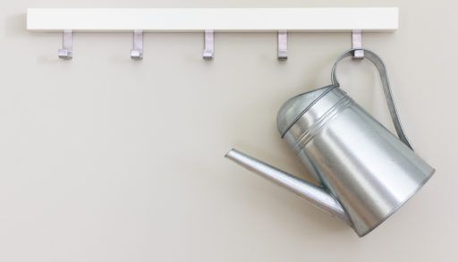 metal-garening-pot-on-hooks-on-wall