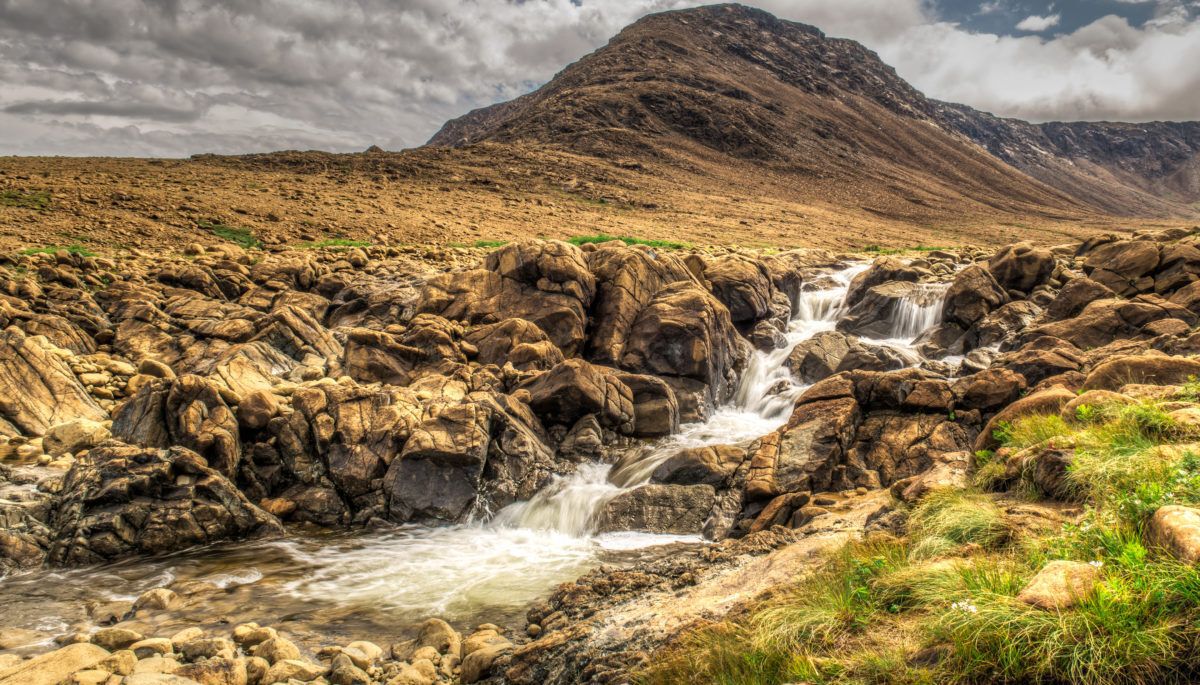 Rocky and grassy Tablelands waterfall in Newfoundland, Canada