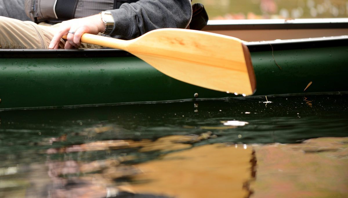 close-up-of-man-with-paddle-on-river-in-canoe