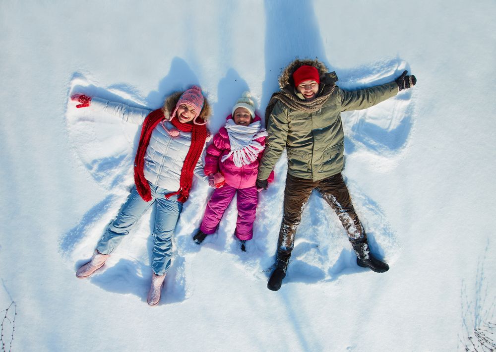 Family making snow angels